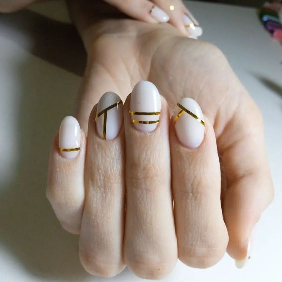 Golden Stripes On Oval Nails